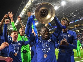 Chelsea's French midfielder N'Golo Kante (C) lifts the trophy after winning the UEFA Champions League final football match between Manchester City and Chelsea FC at the Dragao stadium in Porto on May 29, 2021.