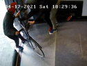 A victim struggles to stop two men from stealing his bicycle at Bathurst and Adelaide Sts. on April 17, 2021.