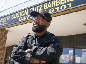Shawn Lewis of Custom Cuts Barbershop on Thursday, May 6, 2021.