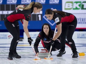 Calgary Ab,May 8, 2021.WinSport Arena at Calgary Olympic Park.LGT World Woman's World Curling Championship.Team Canada skip Kerri Einarson of Gimli Mb follows her front end (L-R) lead Briane Meilleur and 2nd.Shannon Birchard during their qualification game against team Sweden.
