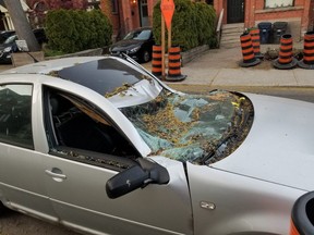 A photo of the smashed car parked along Cowan Ave. in Parkdale