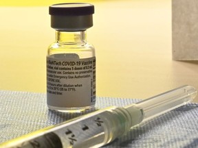 A syringe of the COVID-19 vaccine waits to be administered in Toronto on Monday, Dec. 14, 2020.