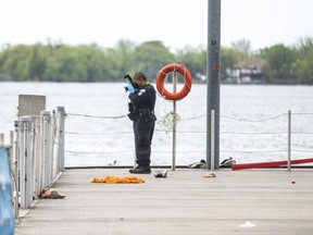 Toronto Police investigate a drowning after a man fell into Lake Ontario near Queens Quay at Lower Simcoe St. in Toronto, Ont., on Saturday, May 22, 2021.