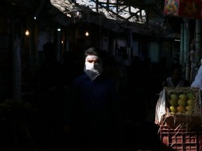 A man wearing a face mask walks in a fruit market amidst the spread of the coronavirus disease (COVID-19) in Mumbai, India, May 11, 2021.