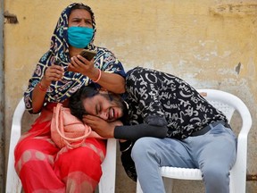 A man mourns after his father died due to the coronavirus disease (COVID-19) outside a mortuary of a COVID-19 hospital in Ahmedabad, India, May 8, 2021.