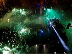 Soccer Football - Primeira Liga - Sporting CP v Boavista - Lisbon, Portugal - May 11, 2021 Sporting CP team bus drives past fans celebrating after winning the Primeira Liga near by Estadio Jose Alvalade.