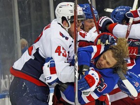 Tom Wilson #43 of the Washington Capitals takes a roughing penalty during the second period against Artemi Panarin #10 of the New York Rangers at Madison Square Garden.