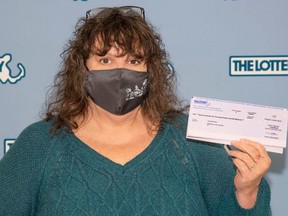 Lea Rose Fiega, of Massachusetts, with her lotto winnings after she threw away the ticket thinking it was worthless.