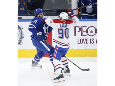 Montreal Canadiens Tomas Tatar LW (90) hits Toronto Maple Leafs John Tavares C (91) during second period action in Toronto on Thursday May 6, 2021. Jack Boland/Toronto Sun/Postmedia Network