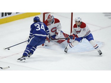 Toronto Maple Leafs Auston Matthews C (34) tries to wrap the puck around Montreal Canadiens Cayden Primeau G (30) during first period action in Toronto on Thursday May 6, 2021. Jack Boland/Toronto Sun/Postmedia Network