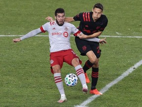 Toronto FC midfielder Alejandro Pozuelo (10) plays the ball against New York Red Bulls midfielder Sean Davis (27) during the second half at Red Bull Arena.