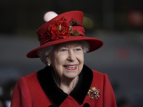 Queen Elizabeth smiles during a visit to HMS Queen Elizabeth at HM Naval Base ahead of the ship's maiden deployment on May 22, 2021 in Portsmouth, England.