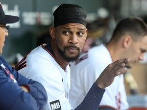Byron Buxton  of the Minnesota Twins looks on in the dugout in the third inning of the game against the Cincinnati Reds at Target Field on June 21, 2021 in Minneapolis.