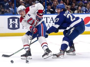 Brendan Gallagher of the Montreal Canadiens is defended by Ryan McDonagh  of the Tampa Bay Lightning during the second period in Game One of the 2021 NHL Stanley Cup Final at Amalie Arena on June 28, 2021 in Tampa, Florida.