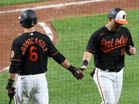 Pat Valaika (right) of the Baltimore Orioles celebrates with Ryan Mountcastle after scoring a run against the Toronto Blue Jays on Friday night.