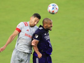 Toronto FC defender Omar Gonzalez (44) and Orlando City forward Tesho Akindele jump for a ball earlier this season.