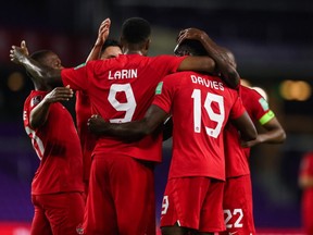 Canada striker Cyle Larin (9) celebrate with Alphonso Davies (19) and teammates after scoring against Bermuda in a 2022 FIFA World Cup Qualifying game in Orlando, Fla., on March 25, 2021. Canada defeated Haiti 3-0 in Bridgeview, Ill., on Tuesday, June 15, 2021, to advance to the final round of CONCACAF Qualifying.