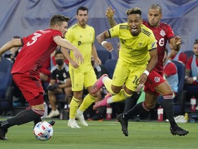 Toronto FC defender Eriq Zavaleta (3) and Nashville SC midfielder Hany Mukhtar (10) vie for the ball during their match.