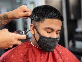 Starting June 29, Ontario residents can go to a salon or barbershop to get their COVID hair lopped off. In this file photo taken on May 8, 2020, a man gets his hair cut in Austin, Texas.