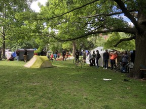 Occupants and activists at a soon-to-be dismantled homeless encampment at Trinity Bellwoods Park in Toronto on Tuesday, June 22 2021
