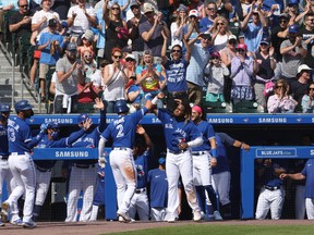 Blue Jays' Joe Panik  celebrates his three-run home run with teammates during the fourth inning against the Houston Astros at Sahlen Field.