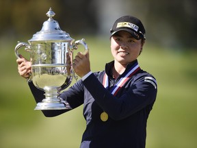 Yuka Saso of the Philippines celebrates with the Harton S. Semple Trophy after winning the 76th U.S. Women’s Open Championship in San Francisco yesterday.