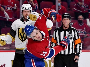 Golden Knights defenceman Brayden McNabb sends Canadiens' Nick Suzuki reeling with a punch to the face, under the eye of referee Chris Lee, during Game 4 on Sunday at the Bell Centre. No penalty was called.