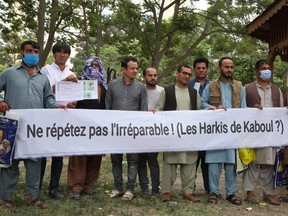 In this file photo taken May 28, 2021, Afghan former interpreters for the French forces gather during a demonstration at Shahr-e Naw Park in Kabul.