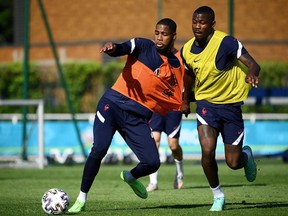 France's goalkeeper Mike Maignan (L) and France's forward Marcus Thuram take part in a training session at the team's training grounds in Clairefontaine-en-Yvelines, southwest of Paris, on June 10, 2021, ahead of the UEFA EURO 2020 football competition.