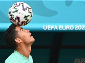 Portugal's forward Cristiano Ronaldo juggles the ball as he takes part in their MD-1 training session in Puskas Arena in Budapest on June 14, 2021, the eve of their UEFA EURO 2020 Group F football match against Hungary. - Portuguese players take part in their training session at the Puskas Arena in Budapest Monday, ahead of the UEFA Euro 2020. USA TODAY SPORTS