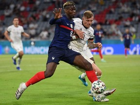 France's midfielder Paul Pogba (L) vies for the ball with Germany's midfielder Toni Kroos during the UEFA EURO 2020 Group F football match between France and Germany at the Allianz Arena in Munich on June 15, 2021.
