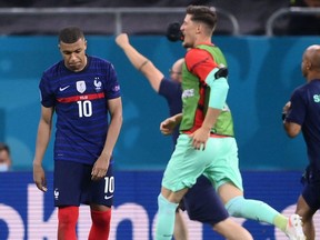 France forward Kylian Mbappe, left, reacts after missing the final penalty during the UEFA EURO 2020 round of 16 football match between France and Switzerland at the National Arena in Bucharest yesterday. Getty images