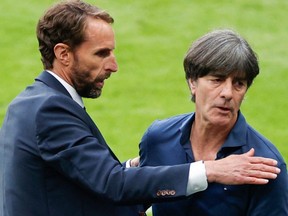 Germany's coach Joachim Loew, right, congratulates England's coach Gareth Southgate after their win in the UEFA EURO 2020 round of 16 football match between England and Germany at Wembley Stadium in London on June 29, 2021.