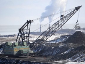 A giant drag line works in the Highvale Coal Mine to feed the nearby Sundance Power Plant near Wabamun, Alta., March 21, 2014.