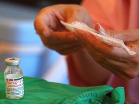 A medical worker prepares a dose of the AstraZeneca vaccine against  COVID-19 during a vaccination session for people over 75 years old, at a stadium in New Taipei City, Taiwan, Friday, June 25, 2021.