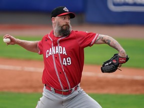 Team Canada relief pitcher John Axford delivers during the eighth inning against Dominica in the Super Round of the WBSC Baseball Americas Qualifier series game at Clover Park.