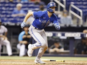 Cavan Biggio of the TorontBlue Jays hits a double during the ninth inning against the Miami Marlins. MICHAEL REAVES/USA TODAY SPORTS