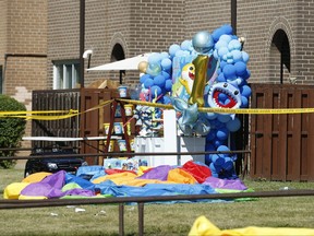 A balloon birthday display for a one-year-old is part of the crime scene as Toronto Police sift through the area where a multi-victim shooting occurred at a housing complex on Tandridge Cres. off of Albion Rd. Saturday, June 19, 2021.