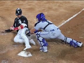 Yasmani Grandal of the Chicago White Sox is tagged out at the plate by Reese McGuire of the Toronto Blue Jays in the 4th inning at Guaranteed Rate Field on June 9, 2021 in Chicago.