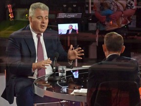 In a handout picture released by the BBC, Britain's Northern Ireland Secretary Brandon Lewis (left) speaks to journalist Andrew Marr during an appearance on the BBC political program The Andrew Marr Show in London, Sunday, June 27, 2021.