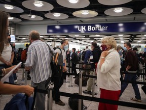 Arriving passengers queue at U.K. Border Control at the Terminal 5 at Heathrow Airport in London, Britain June 29, 2021.