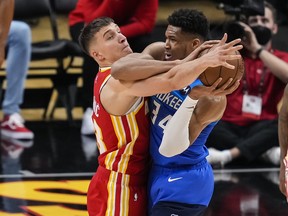 Milwaukee Bucks forward Giannis Antetokounmpo tries to protect the ball defended by Atlanta Hawks guard Bogdan Bogdanovic in the first half during game three of the Eastern Conference Finals for the 2021 NBA Playoffs at State Farm Arena in Atlanta, Ga., June 27, 2021.