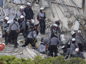 Search and rescue teams look for possible survivors and remains in the partially collapsed 12-story Champlain Towers South condo building in Surfside, Fla., Tuesday, June 29, 2021.