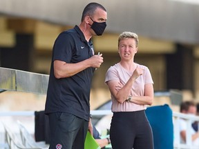 Canada head coach Bev Priestman, right, speaks to assistant Michael Norris during a game in Cartagena, Spain on June 11, 2021. Canada tied Brazil 0-0 on Monday.