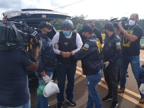 Argentine golfer Angel Cabrera is led handcuffed by police officers after being extradited from Brazil, in Misiones, Argentina June 8, 2021.
