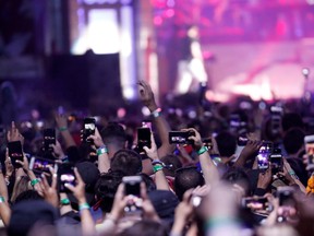 Concertgoers use their mobile phones during Eminem's performance at the Coachella Valley Music and Arts Festival in Indio, Calif., April 15, 2018.