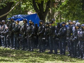 A column of police officers clears a homeless encampment at the northern side of Trinity Bellwoods Park in Toronto on Tuesday, June 22, 2021. ERNEST DOROSZUK/TORONTO SUN