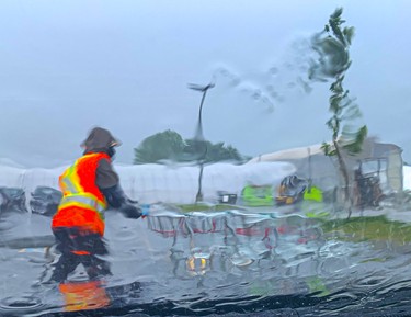 Workers clear carts regardless of the heavy downpour on Tuesday June 29, 2021. Veronica Henri/Toronto Sun/Postmedia Network