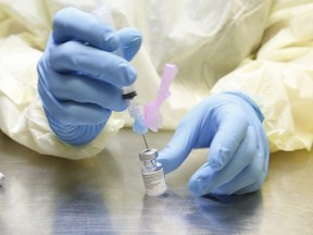 UHN (University Health Network) health-care technicians prepare syringes of the Pfizer-BioNTech COVID-19 vaccine for front-line health-care workers at a UHN clinic at the MaRS building on Jan. 7, 2021.