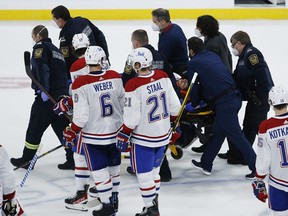 Montreal Canadiens' Jake Evans (71) is taken off the ice on a stretcher after getting hit by Winnipeg Jets' Mark Scheifele (55) during third period NHL Stanley Cup hockey action in Winnipeg, Wednesday, June 2, 2021.